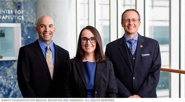 Three staff physicians from Mayo Clinic Men's Health smile in greeting.